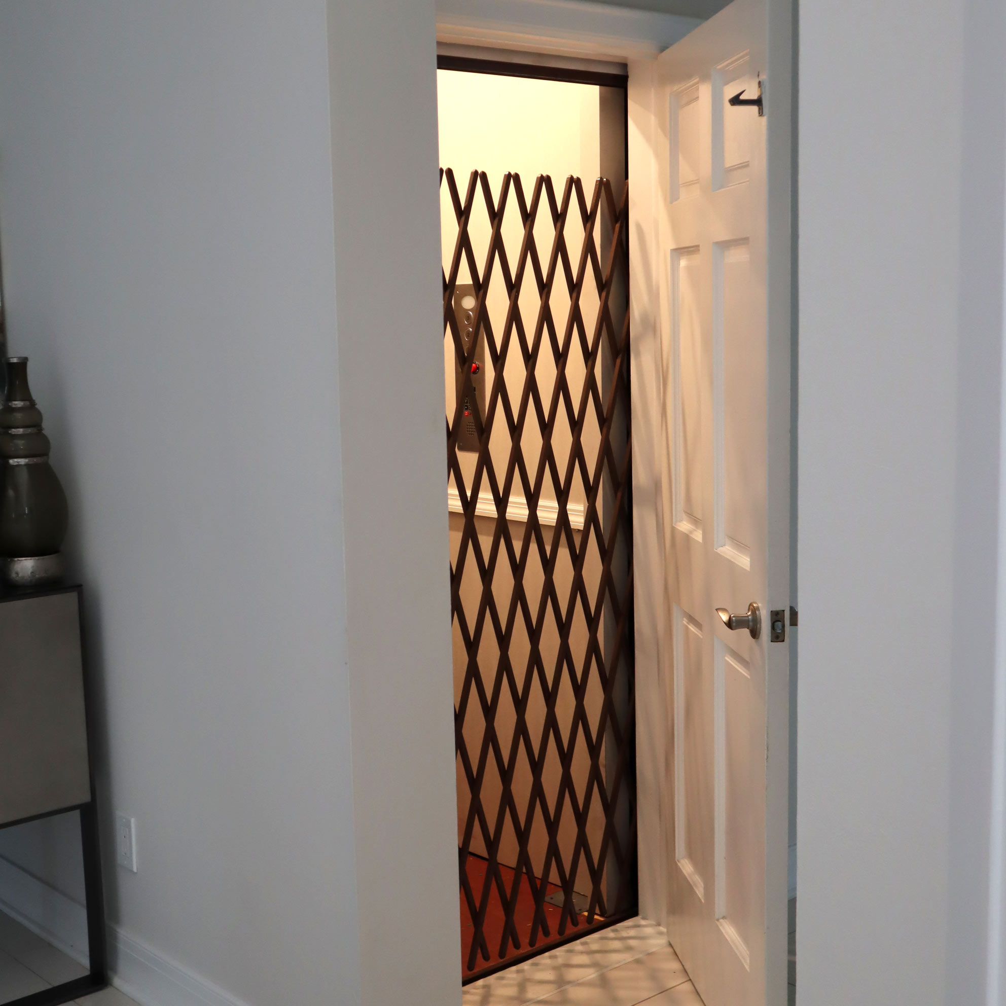 Gated elevator accessed by closet in a home